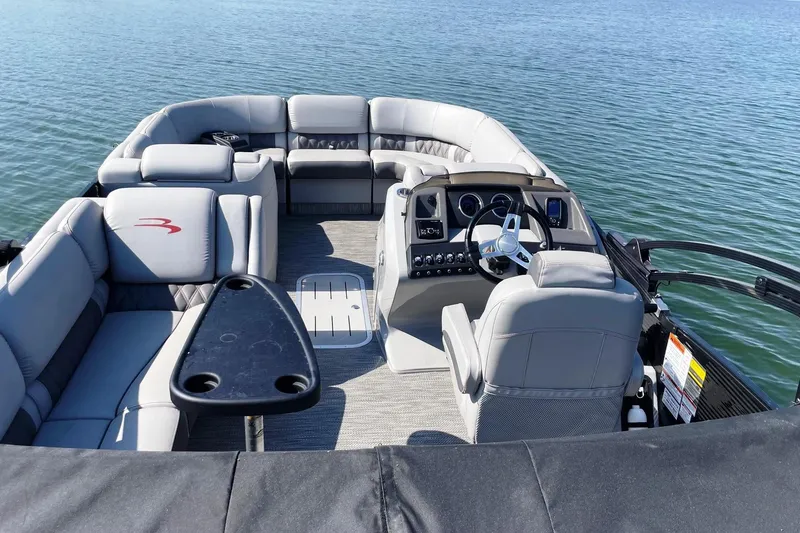 Slide: The Image of 2020 Bennington 22RSB pontoon boat interior with plush seating and steering console. - 12