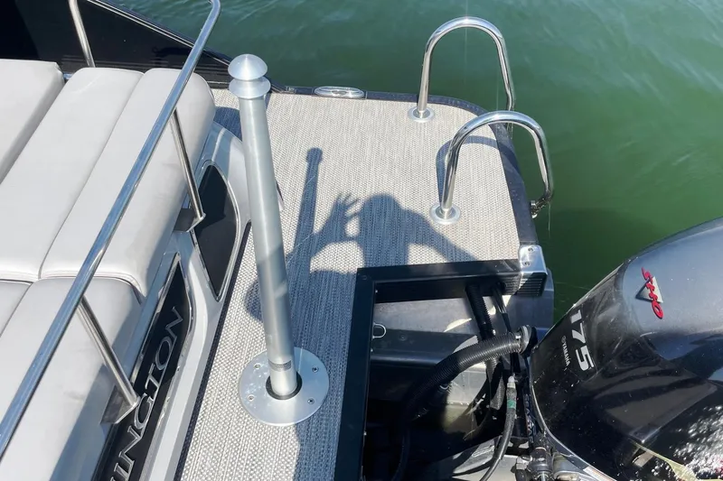 Slide: The Image of 2020 Bennington 22RSB boat deck with Yamaha 175 engine, shadow on carpeted surface. - 14