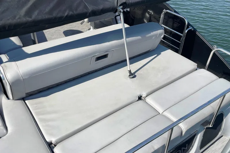 Slide: The Image of 2020 Bennington 22RSB boat with cushioned seating and railing, docked on water. - 15