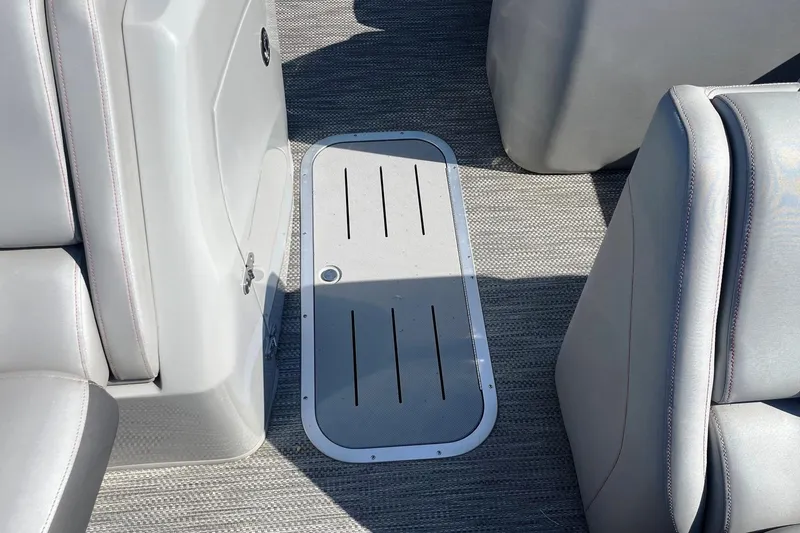 Slide: The Image of 2020 Bennington 22RSB boat interior with gray seating and floor storage compartment. - 8