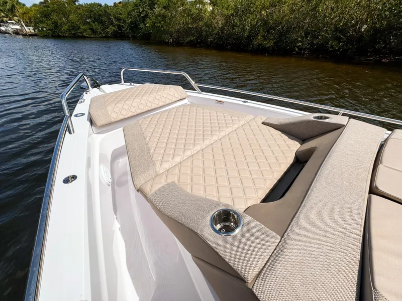 Slide: The Image of 2024 Axopar 37XC CROSS CABIN with luxurious beige seating on a calm river. - 10