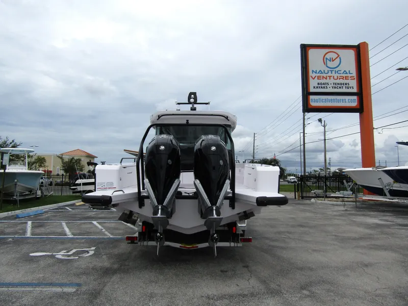 Slide: The Image of 2024 Axopar 37XC CROSS CABIN with dual engines at Nautical Ventures dealership. - 2