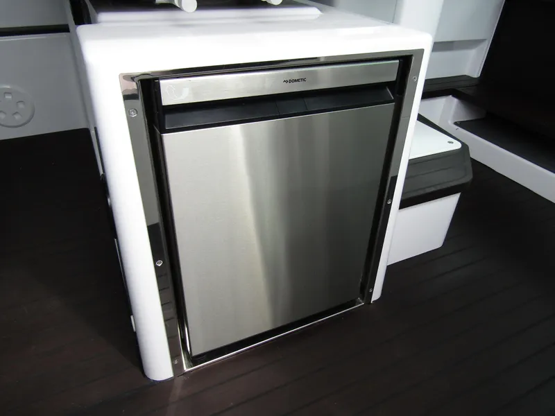 Slide: The Image of Stainless steel fridge in 2024 Axopar 37XC CROSS CABIN boat interior. - 23