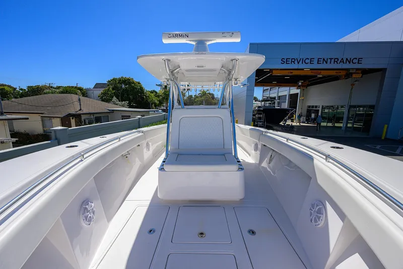 Slide: The Image of 2017 SeaHunter 33 Tournament boat at service entrance, featuring spacious deck and Garmin equipment. - 12