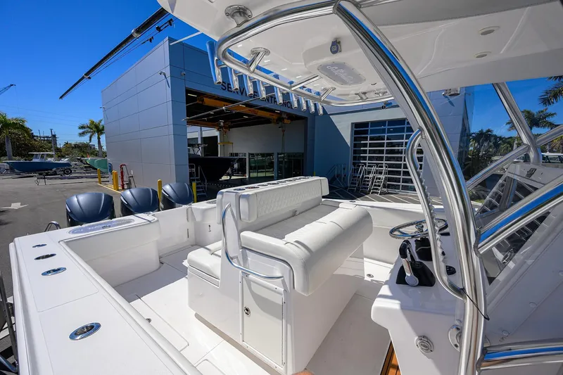 Slide: The Image of 2017 SeaHunter 33 Tournament boat interior with white seating and modern controls. - 13
