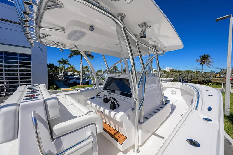 Slide: The Image of 2017 SeaHunter 33 Tournament boat with sleek design and modern console, under clear blue sky. - 14