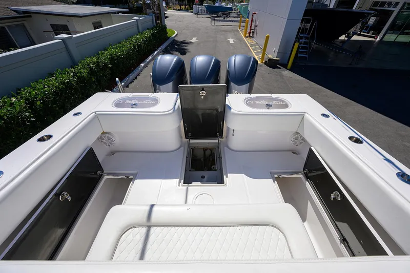Slide: The Image of 2017 SeaHunter 33 Tournament boat interior with storage compartments and triple engines. - 15