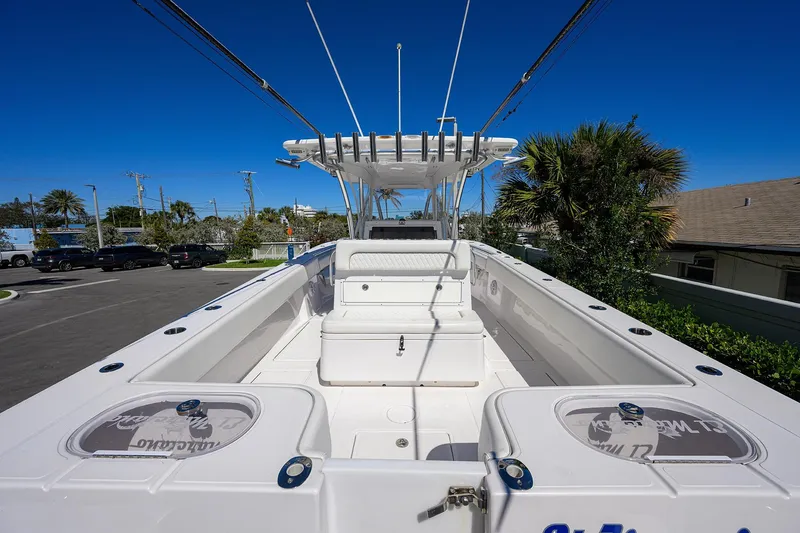 Slide: The Image of 2017 SeaHunter 33 Tournament boat with spacious deck and seating, under clear blue sky. - 16