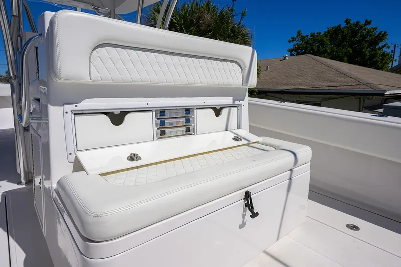 Slide: The Image of 2017 SeaHunter 33 Tournament boat with white cushioned seating and storage compartments. - 18