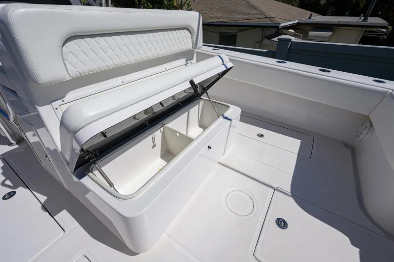 Slide: The Image of 2017 SeaHunter 33 Tournament boat with open storage compartment and cushioned seating. - 19