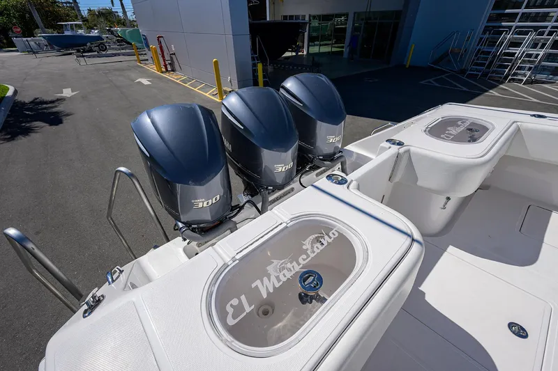 Slide: The Image of 2017 SeaHunter 33 Tournament boat with triple Yamaha 300 engines, docked outdoors. - 21
