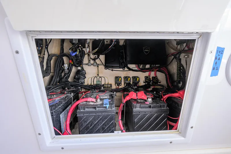Slide: The Image of Electrical compartment of 2017 SeaHunter 33 Tournament boat with batteries and wiring. - 26