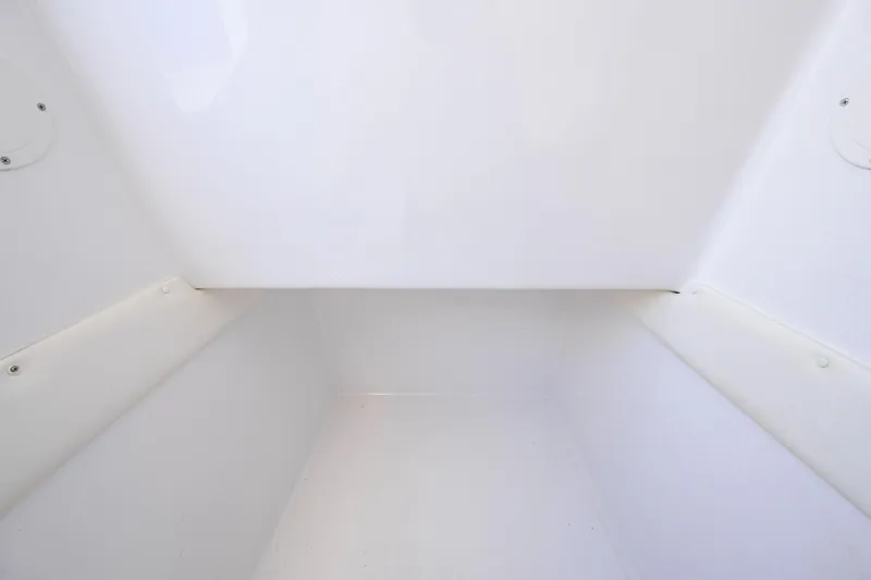 Slide: The Image of Interior storage compartment of 2017 SeaHunter 33 Tournament boat, featuring clean white finish. - 27