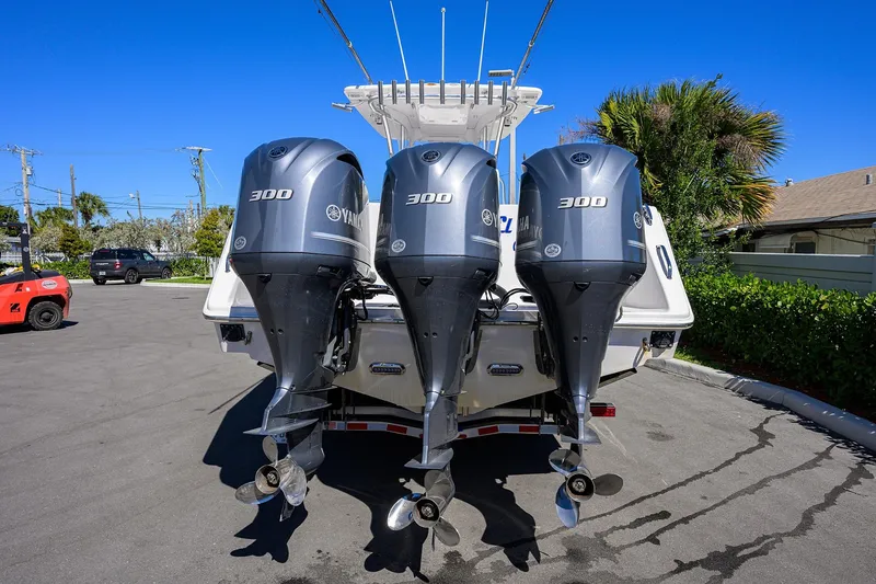Slide: The Image of 2017 SeaHunter 33 Tournament boat with triple Yamaha 300 engines, parked outdoors. - 4