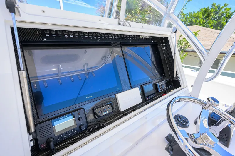 Slide: The Image of 2017 SeaHunter 33 Tournament helm with dual Garmin displays and steering wheel. - 7