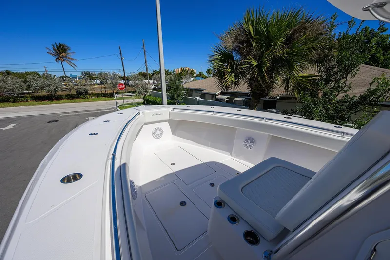 Slide: The Image of 2017 SeaHunter 33 Tournament boat deck with seating, under clear blue sky. - 9