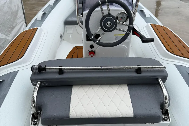 Slide: The Image of Interior view of 2026 Gala A300L boat with steering wheel and cushioned seating. - 10