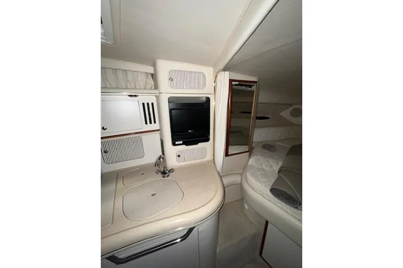 Slide: The Image of 2001 Sea Ray 340 Sundancer cabin interior with kitchenette and sleeping area. - 12
