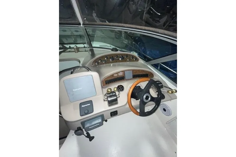 Slide: The Image of Helm of 2001 Sea Ray 340 Sundancer with steering wheel and navigation controls. - 17