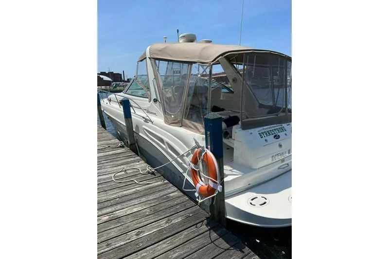 Slide: The Image of 2001 Sea Ray 340 Sundancer docked with canopy and life preserver. - 2