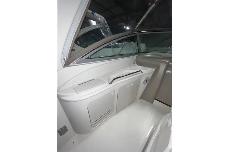Slide: The Image of Interior view of 2001 Sea Ray 340 Sundancer boat, featuring sleek cabinetry and window. - 20