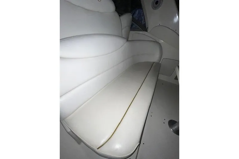 Slide: The Image of White leather seating on a 2001 Sea Ray 340 Sundancer boat interior. - 21
