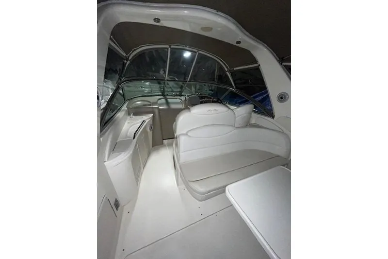 Slide: The Image of Interior of 2001 Sea Ray 340 Sundancer boat with white seating and helm. - 23