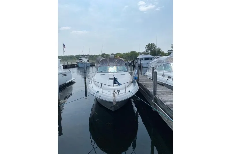 Slide: The Image of 2001 Sea Ray 340 Sundancer docked at a marina, surrounded by other boats. - 32