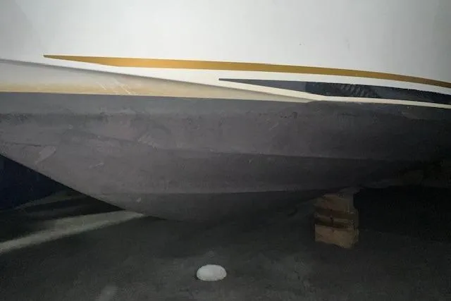 Slide: The Image of 2001 Sea Ray 340 Sundancer boat hull on blocks in storage. - 33