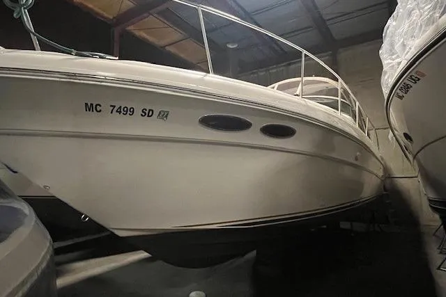 Slide: The Image of 2001 Sea Ray 340 Sundancer boat stored indoors, side view with visible registration number. - 35