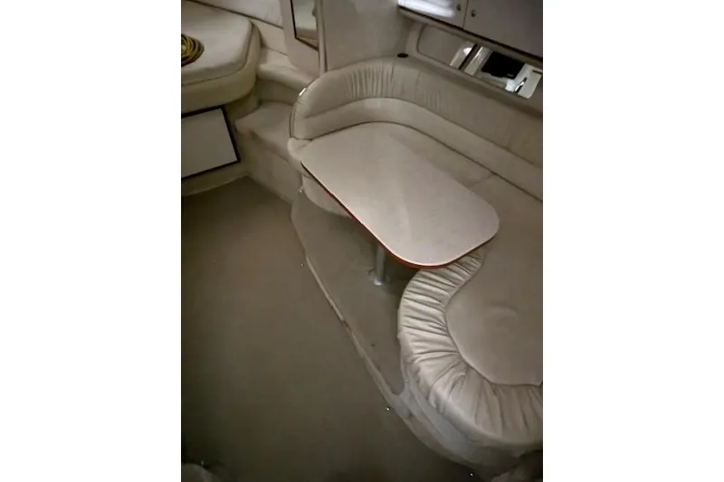 Slide: The Image of Interior of 2001 Sea Ray 340 Sundancer with beige seating and table. - 36