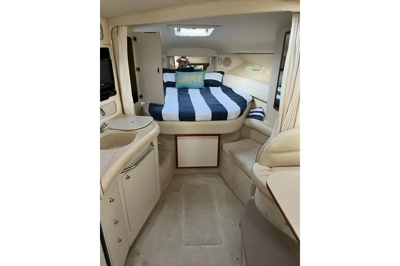 Slide: The Image of Interior of 2001 Sea Ray 340 Sundancer with cozy bed and compact kitchenette. - 4