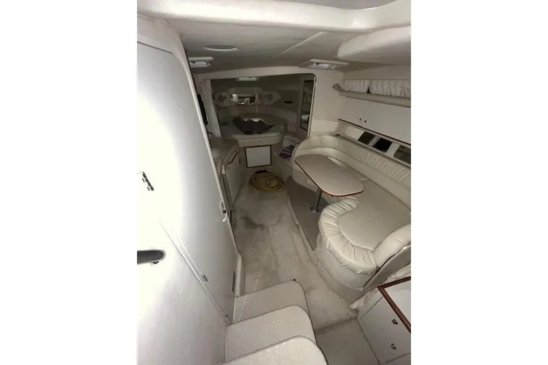 Slide: The Image of Interior of 2001 Sea Ray 340 Sundancer yacht with white seating and compact design. - 5