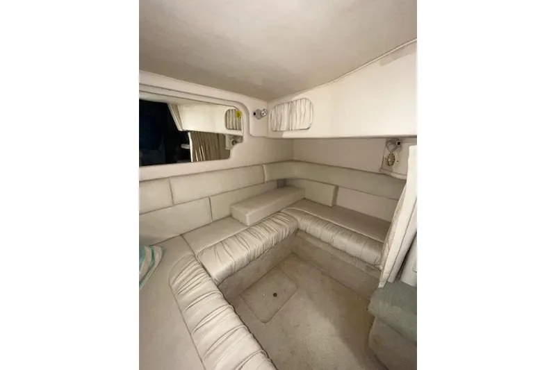 Slide: The Image of Interior of 2001 Sea Ray 340 Sundancer with beige seating and compact design. - 7
