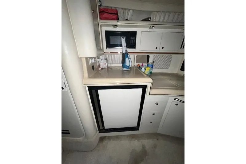 Slide: The Image of 2001 Sea Ray 340 Sundancer interior kitchen with microwave and mini fridge. - 9
