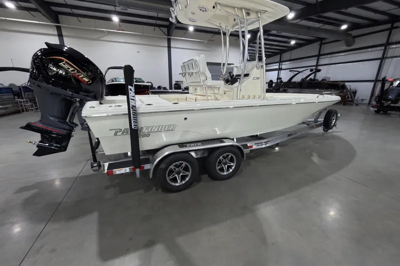 The Image of 2026 Pathfinder 2200 TRS boat on trailer in indoor showroom. - 1