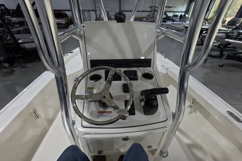 Slide: The Image of 2026 Pathfinder 2200 TRS boat console with steering wheel and controls in showroom. - 10