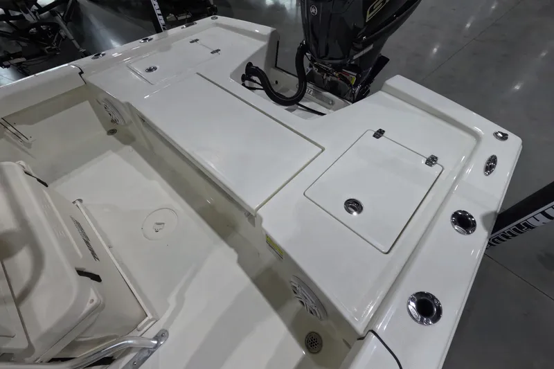 Slide: The Image of 2026 Pathfinder 2200 TRS boat deck with storage compartments and motor. - 11