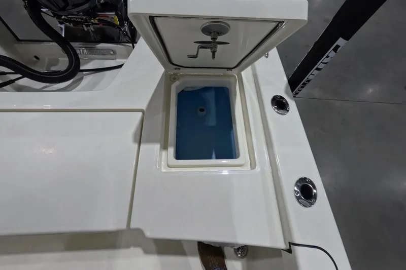 Slide: The Image of 2026 Pathfinder 2200 TRS boat livewell with open lid and blue interior. - 13