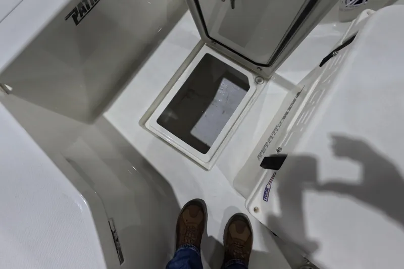 Slide: The Image of Interior view of 2026 Pathfinder 2200 TRS boat, featuring storage compartment and deck details. - 20