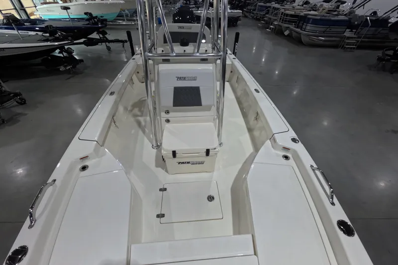 Slide: The Image of 2026 Pathfinder 2200 TRS boat interior with seating and storage, displayed in a showroom. - 21