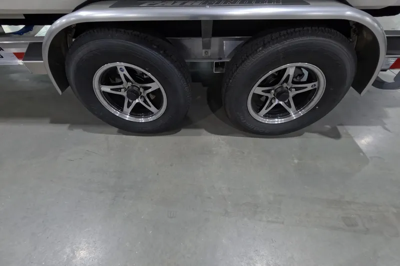 Slide: The Image of 2026 Pathfinder 2200 TRS trailer wheels on concrete floor. - 24