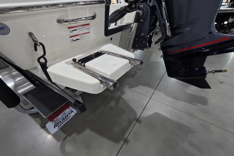 Slide: The Image of 2026 Pathfinder 2200 TRS boat stern with ladder and outboard motor in showroom. - 25