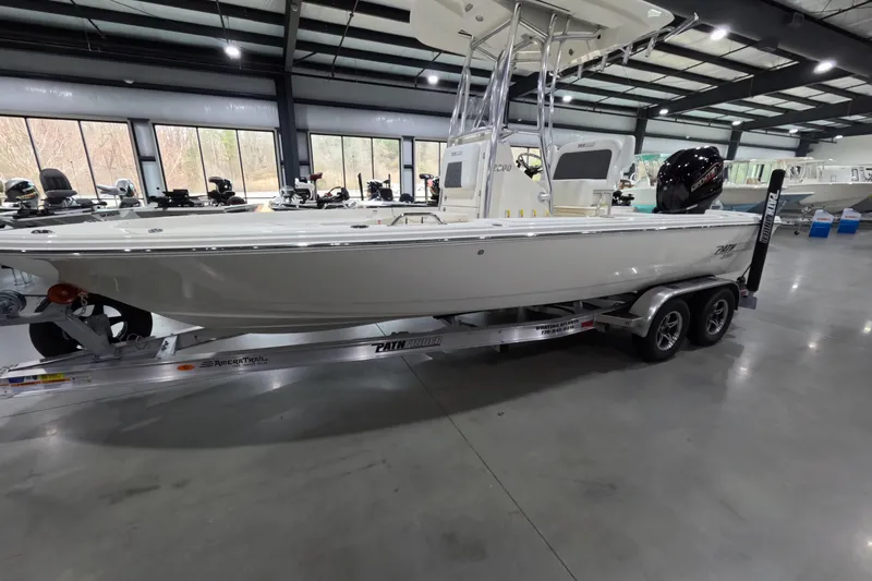 Slide: The Image of 2026 Pathfinder 2200 TRS boat on trailer in showroom setting. - 3