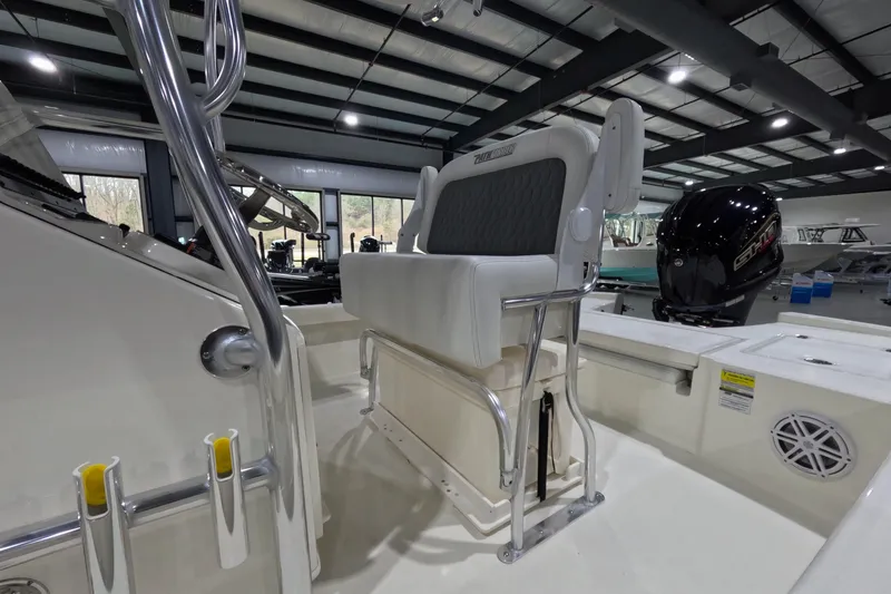 Slide: The Image of 2026 Pathfinder 2200 TRS boat interior with seating and motor in showroom. - 4