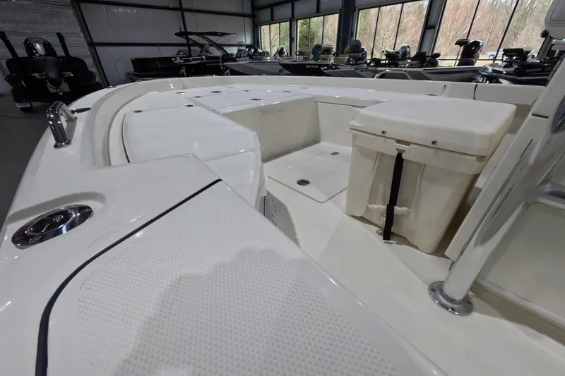 Slide: The Image of 2026 Pathfinder 2200 TRS boat interior with seating and storage in showroom. - 6