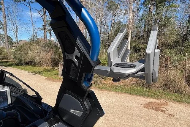 Slide: The Image of 2024 Supra SE 550 boat tower with wakeboard rack in a wooded area. - 16