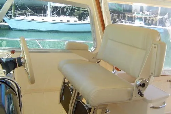 Slide: The Image of Captain's seat on 2002 Island Packet Packet Craft Express 360 yacht, with marina view. - 11