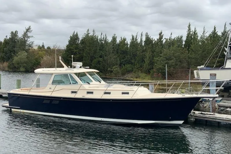 Slide: The Image of 2002 Island Packet Packet Craft Express 360 docked by a forested shoreline. - 2