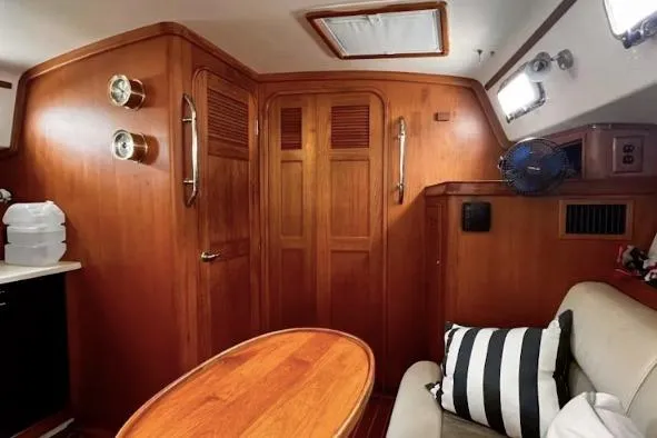 Slide: The Image of 2002 Island Packet Packet Craft Express 360 cabin interior with wood finish and seating area. - 27